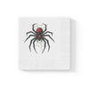 Black Widow Spider cocktail napkin with embossed edges and vivid red abdomen design on white three-ply paper.