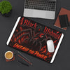 Black Widow 'Unleash the Power' Desk Mat with gothic spider design and fiery red-orange accents on textured neoprene surface